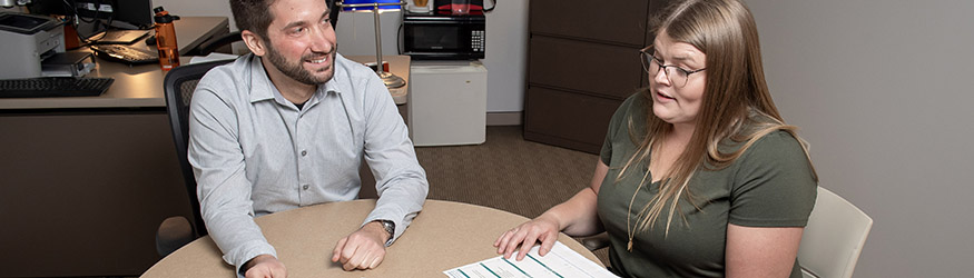 photo of a student and advisor sitting at a table