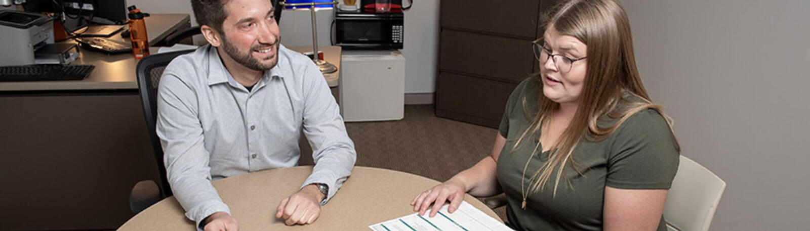 photo of a student and advisor sitting at a table