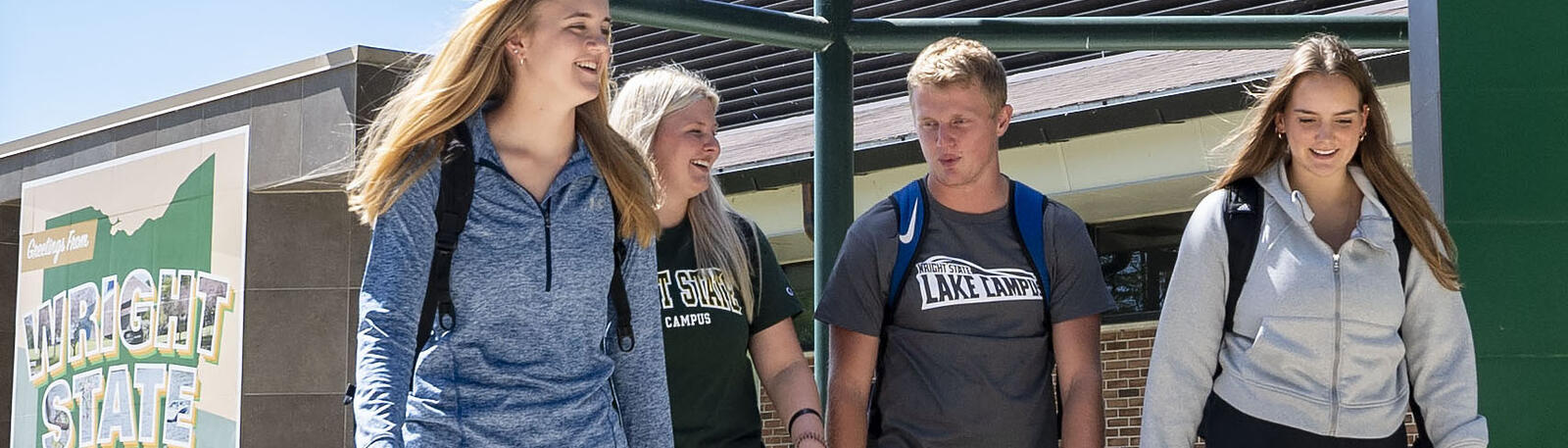 students walking outside of a campus building