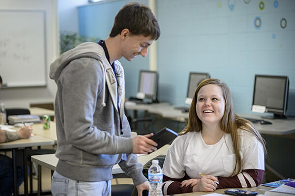students talking at desk